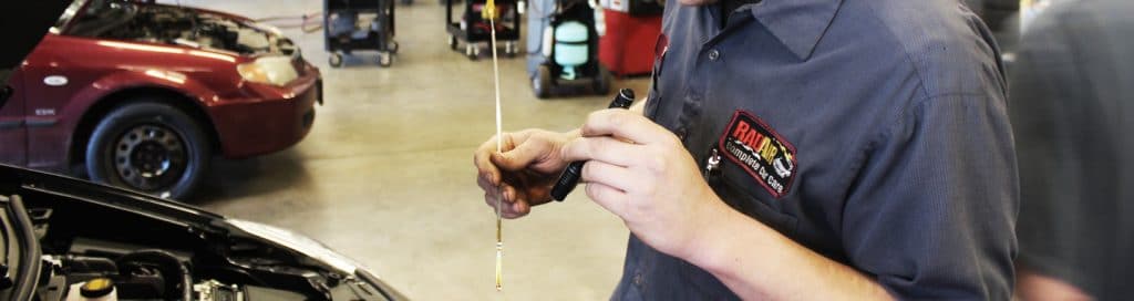 Mechanic Checking Oil Level