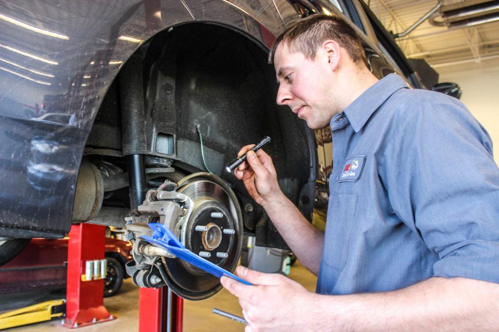 Rad Air technician inspecting brakes