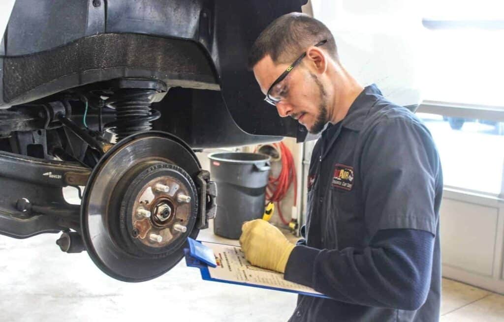 rad air employee inspecting brakes