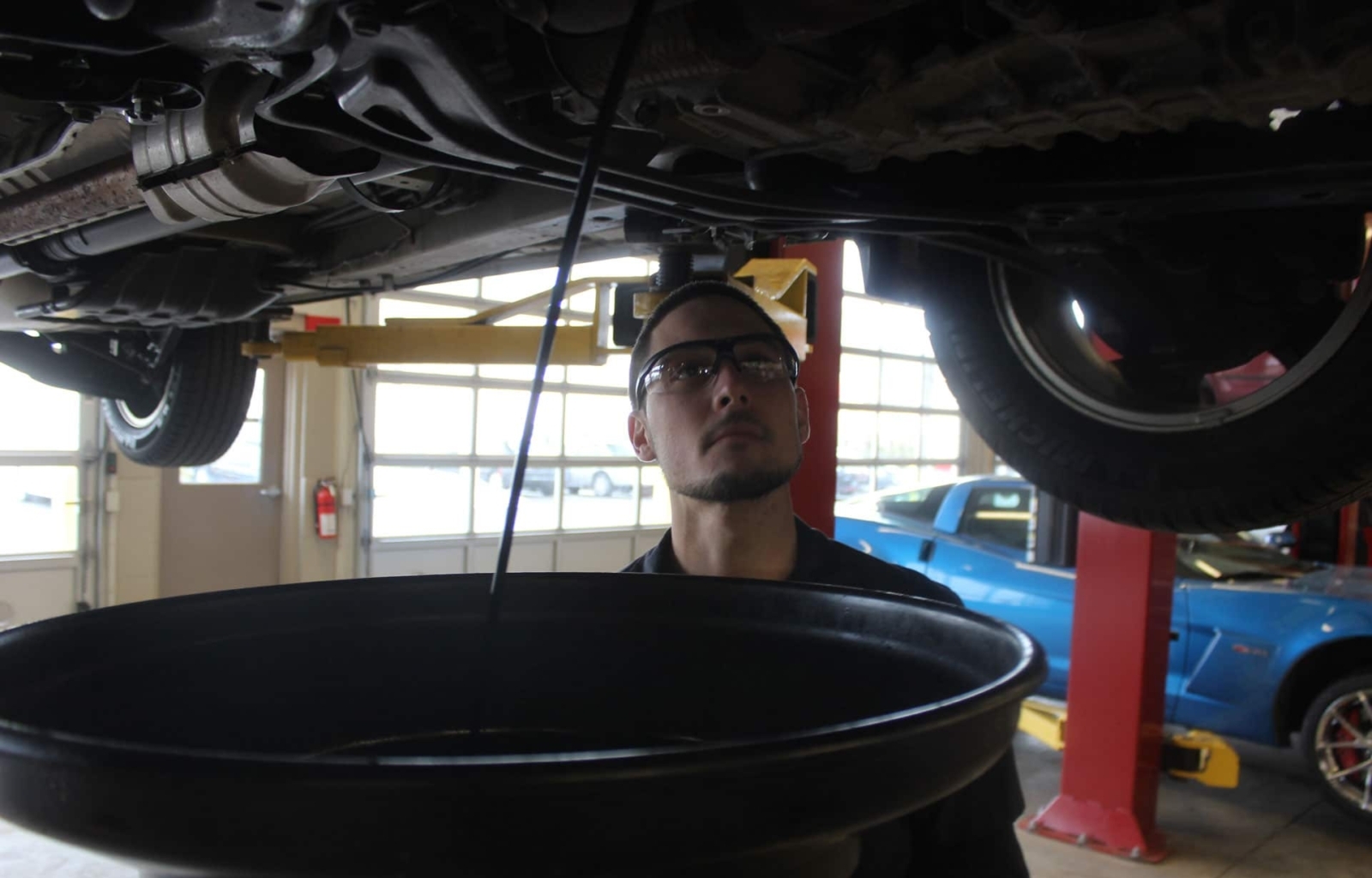 Technician performing an oil change inspection