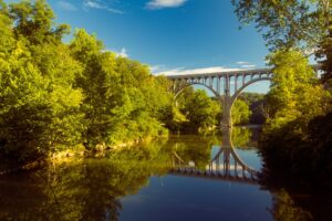 Arch bridge spanning a river in Cuyahoga Valley National Park | Rad Air Complete Car Care Arch bridge spanning a river in Cuyahoga Valley National Park