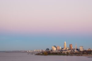| Rad Air Complete Car Care The Cleveland skyline with a pink sky on the coast of Lake Erie for sunset