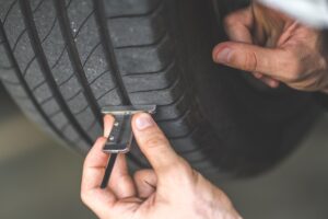 Mechanic checking checking the depth of car tire tread Car maintenance and auto service garage concept | Rad Air Complete Car Care Mechanic checking checking the depth of car tire tread Car maintenance and auto service garage concept