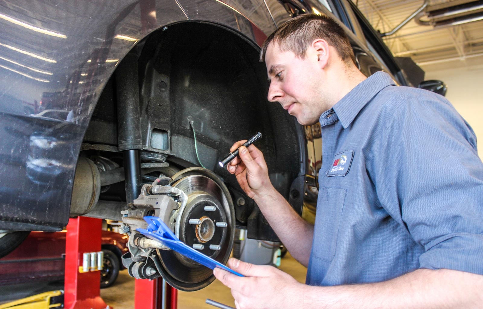 Rad Air technician inspecting a vehicle's brakes