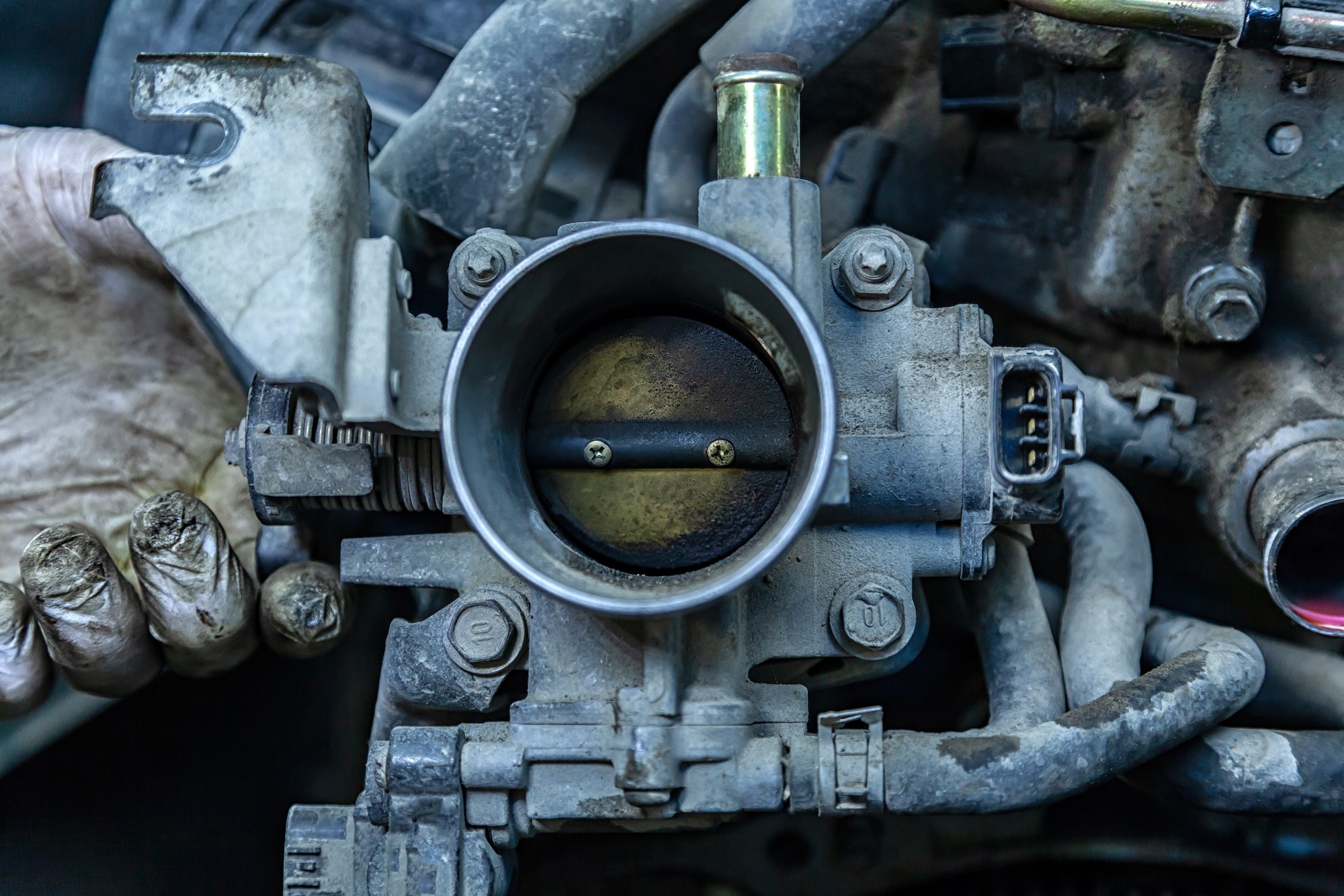 Throttle body with carbon buildup that can cause rough idle and vibration