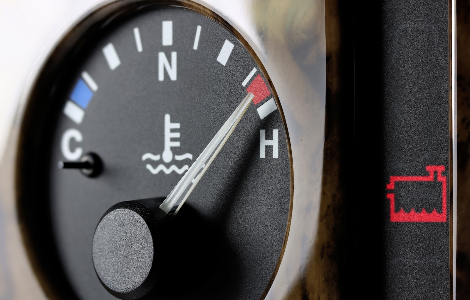 Overheating car with steam rising from under the hood